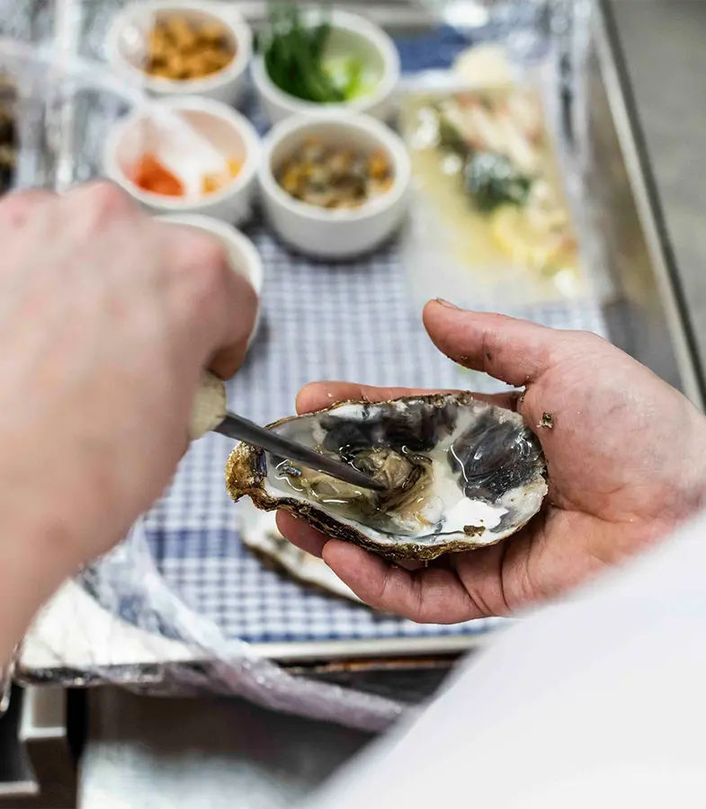 Chef serving oysters at Seafood and Grill restaurant at The Brudenell Hotel, Aldeburgh