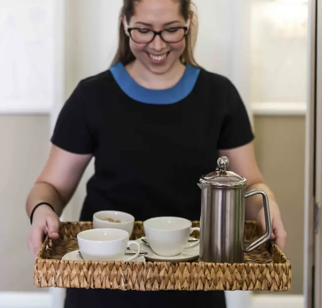 Folk carrying room service breakfast tray at The Brudenell Hotel, Aldeburgh