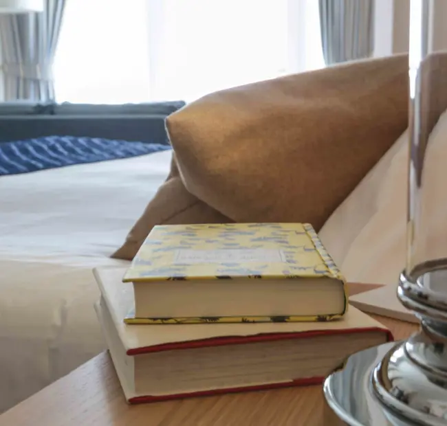 Bedside table with books at The Brudenell Hotel, Aldeburgh