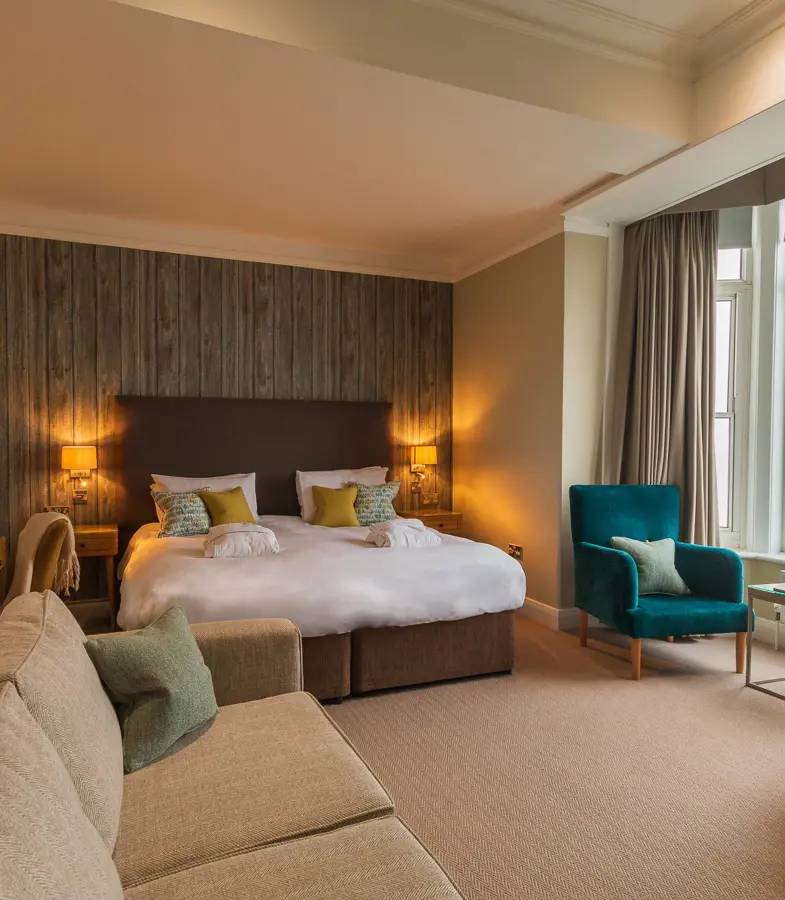 The Brudenell Hotel, Aldeburgh, Deluxe Seaview room, whole room showing bed, seating area and window with sea view