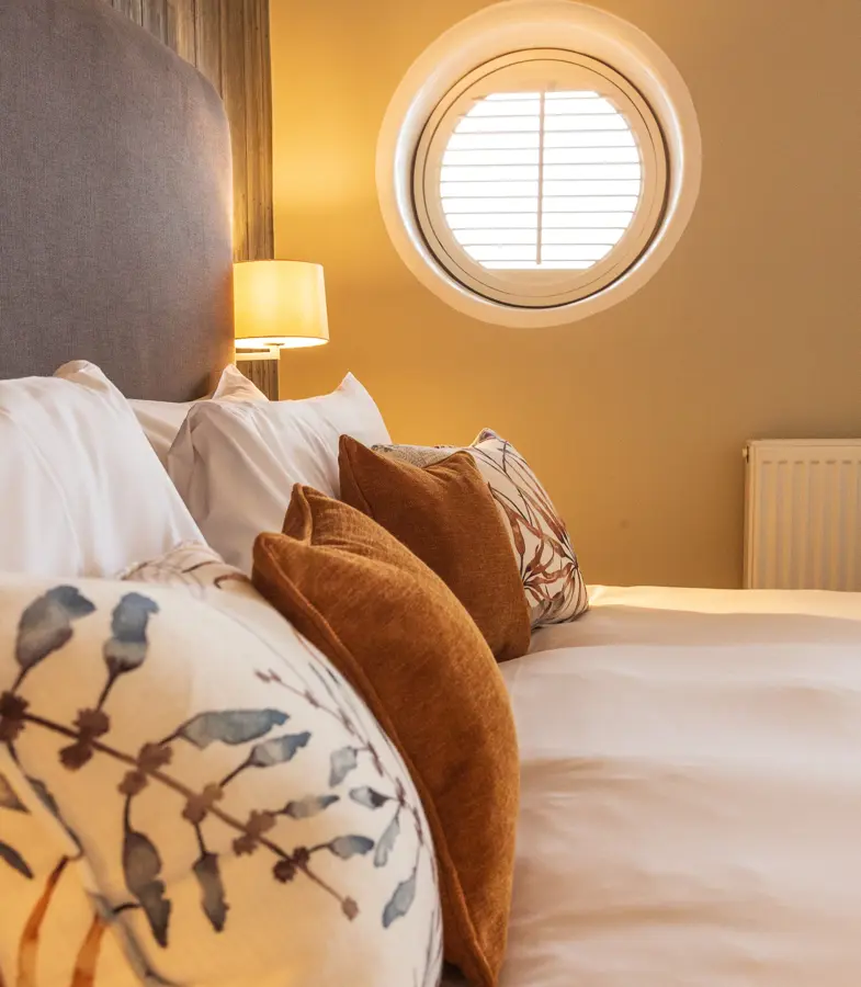 The Brudenell Hotel, Aldeburgh, Deluxe Seaview room, close up on pillows and port hole